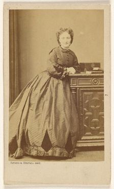 Unidentified woman standing, leaning against a credenza, about 1861. Creator: Bayard & Bertall