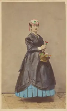 Unidentified woman wearing a flowered hat, holding single flower in one hand, basket of...1862-1865. Creator: Carlo Ponti