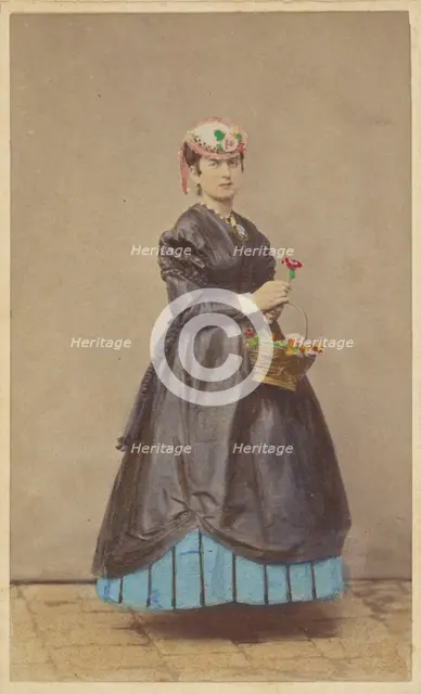 Unidentified woman wearing a flowered hat, holding single flower in one hand, basket of...1862-1865. Creator: Carlo Ponti.