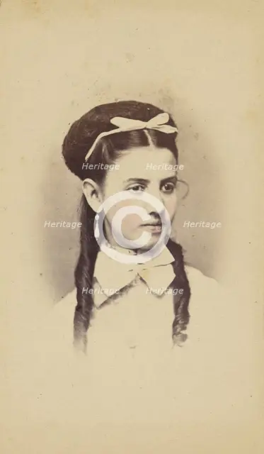 Unidentified young woman with two long curls, wearing a white bow in hair, 1870-1875. Creator: C.L. Lochman.