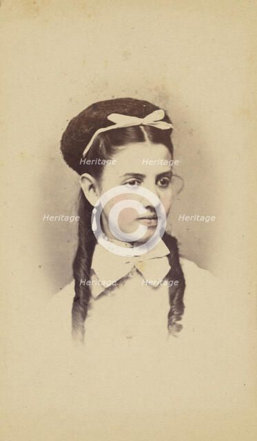 Unidentified young woman with two long curls, wearing a white bow in hair, 1870-1875. Creator: C.L. Lochman.