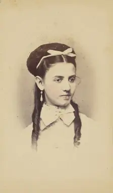 Unidentified young woman with two long curls, wearing a white bow in hair, 1870-1875. Creator: C.L. Lochman
