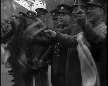 Uniformed British Soldiers Cheering and Smiling Whilst Waving Flags, 1937. Creator: British Pathe Ltd