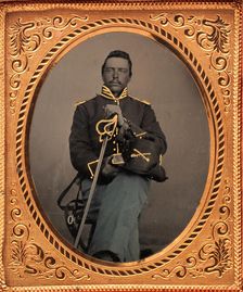Union Cavalry Officer Displaying Sword, Holding Hat, Seated in Studio, 1861-65. Creator: Unknown