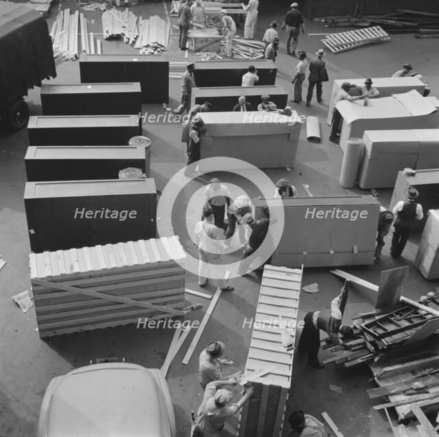 United States government workers and carpenters making crates for steel..., Washington, D.C., 1942. Creator: Gordon Parks.