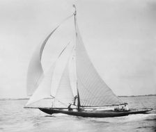 Unknown cutter sailing with spinnaker. Creator: Kirk & Sons of Cowes