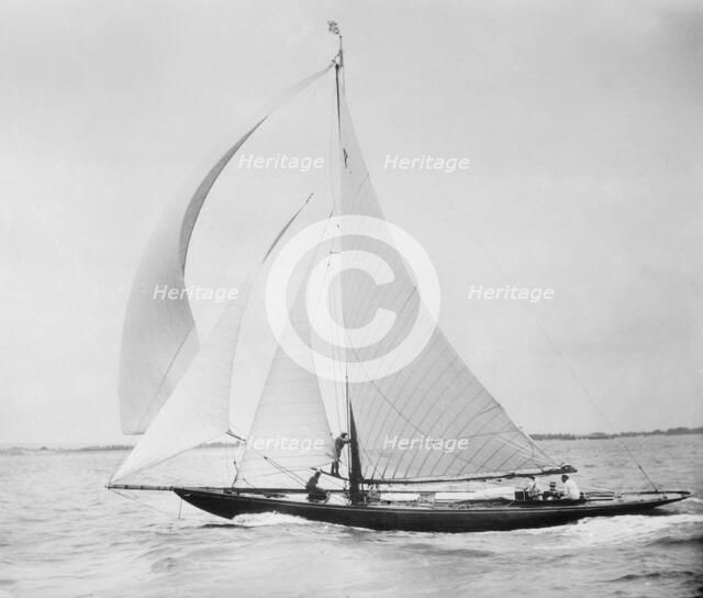 Unknown cutter sailing with spinnaker. Creator: Kirk & Sons of Cowes.