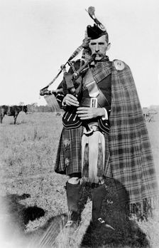 Unknown man in full Scottish kilt with bagpipes, c1900s. Creator: Robert Augustus Henry L'Estrange