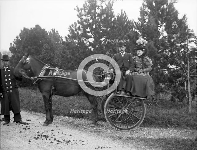 Unknown people in horse drawn cart and coachman; possibly Chester, England (Bache Hall), 1895. Creator: Robert Augustus Henry L'Estrange.