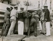 Unloading a case from H.M.S. Suffolk at Portsmouth, July 1935. Creator: Topical Press Agency