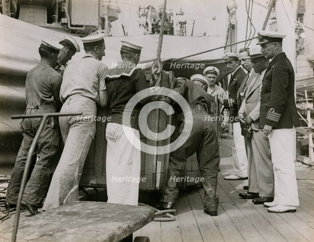 Unloading a case from H.M.S. Suffolk at Portsmouth, July 1935. Creator: Topical Press Agency.