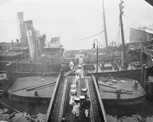 Unloading a fishing boat, Billingsgate market, London, 1923. Creator: Unknown