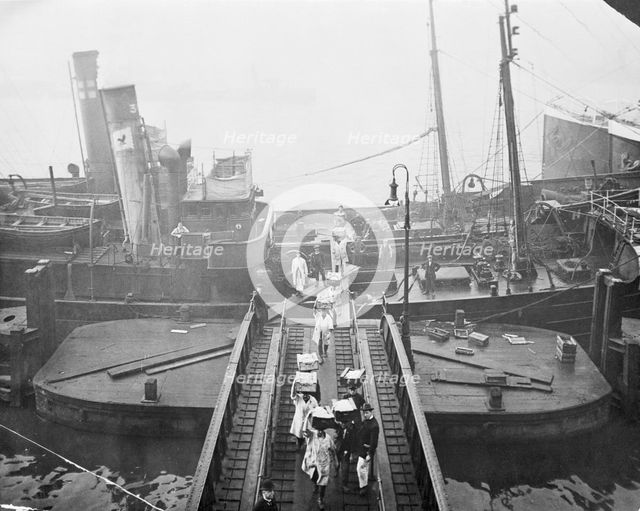 Unloading a fishing boat, Billingsgate market, London, 1923. Creator: Unknown.