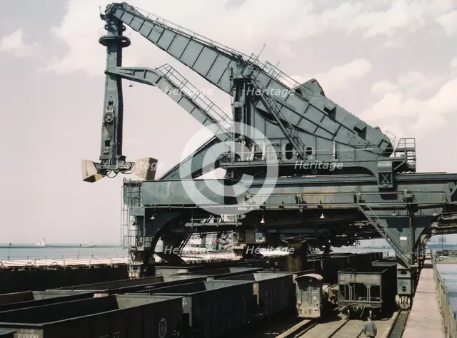 Unloading a lake freighter at the Pennsylvania Railroad iron ore docks...Cleveland, Ohio, 1943. Creator: Jack Delano.
