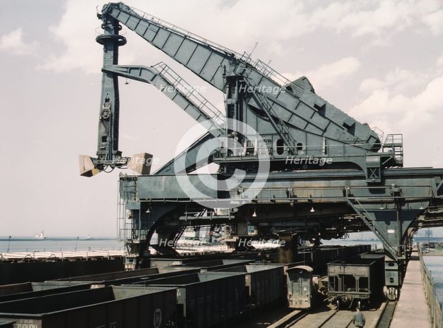 Unloading a lake freighter at the Pennsylvania Railroad iron ore docks...Cleveland, Ohio, 1943. Creator: Jack Delano.