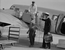 Unloading baggage for inspection...plane from Mexico, Glendale Airport, California, 1937. Creator: Dorothea Lange