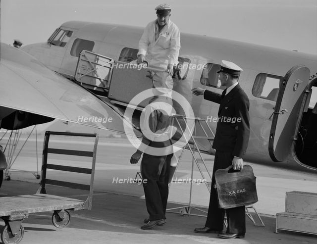 Unloading baggage for inspection...plane from Mexico, Glendale Airport, California, 1937. Creator: Dorothea Lange.