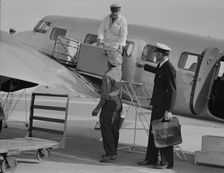 Unloading baggage for inspection...plane from Mexico, Glendale Airport, California, 1937. Creator: Dorothea Lange