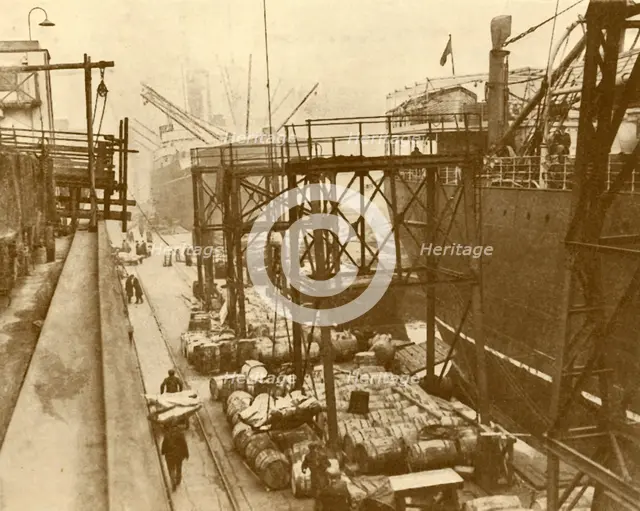 'Unloading Foodships at the Royal Albert Docks, London', c1930. Creator: Unknown.