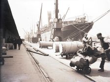 Unloading rolls of paper from a ship, London, c1905