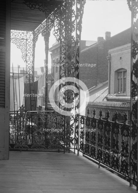 Upper level balconies with wrought iron on St. Peter Street, New Orleans, between 1920 and 1926. Creator: Arnold Genthe.