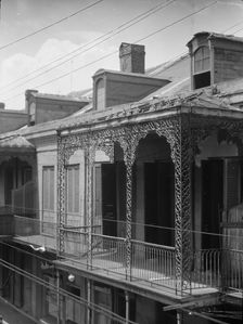 Upper story of building with wrought iron balconies, New Orleans, between 1920 and 1926. Creator: Arnold Genthe
