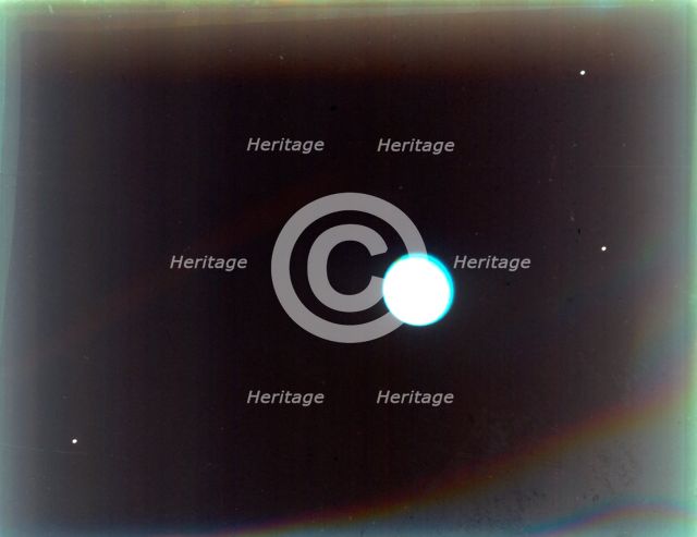 Uranus with satellites Miranda, Ariel and Umbriel, from Voyager 2, 24 January 1986. Creator: NASA.