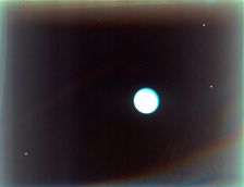 Uranus with satellites Miranda, Ariel and Umbriel, from Voyager 2, 24 January 1986. Creator: NASA