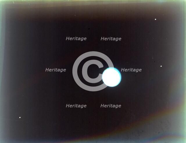 Uranus with satellites Miranda, Ariel and Umbriel, from Voyager 2, 24 January 1986. Creator: NASA.