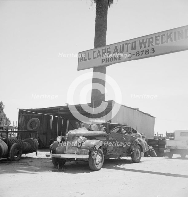 Used car lots and auto wrecking establishments, U.S. 99,  Near Tulare, California, 1939. Creator: Dorothea Lange.