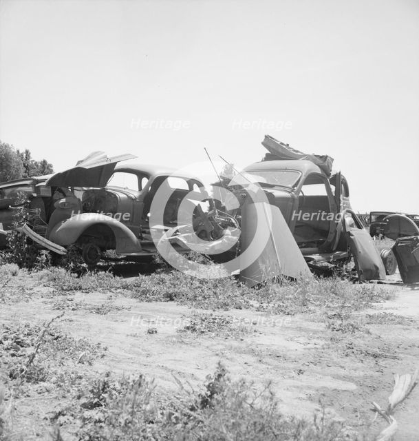 Used car lots and auto wrecking establishments, U.S. 99,  Near Tulare, California, 1939. Creator: Dorothea Lange.