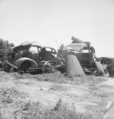 Used car lots and auto wrecking establishments, U.S. 99, Near Tulare, California, 1939. Creator: Dorothea Lange