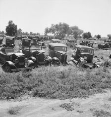 Used car lots and auto wrecking establishments, U.S. 99, Near Tulare, California, 1939. Creator: Dorothea Lange