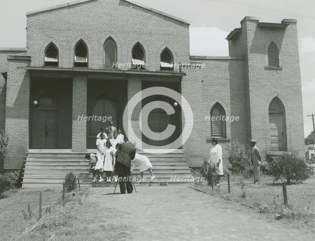 Ushers of an African American church standing on church steps and getting ready to pose..., May 1940 Creators: Farm Security Administration, Jack Delano.