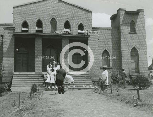 Ushers of an African American church standing on church steps and getting ready to pose..., May 1940 Creators: Farm Security Administration, Jack Delano.