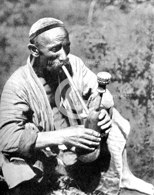 Uzbek man smoking calian, Samarkand, 1936. Artist: Unknown