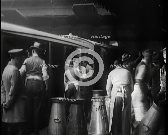 Volunteer Male Civilians Lifting Milk Churns and Helping Deliver Milk, 1926. Creator: British Pathe Ltd.