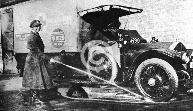 Volunteer English woman driver washing down her ambulance, Cambridge, World War I, 1915. Artist: Unknown