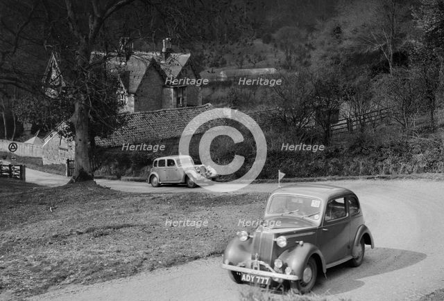 Vauxhall 10 of Miss IM Burton amd Rover of CG Dunham competing in the RAC Rally, 1939. Artist: Bill Brunell.