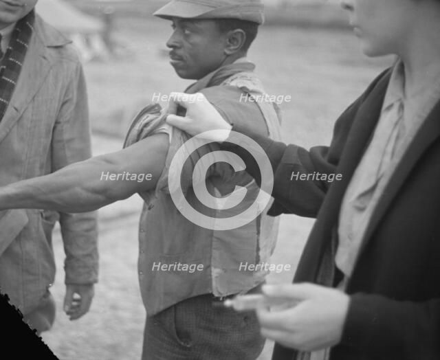 Vaccination in the camp for Negro flood refugees at Marianna, Arkansas, 1937. Creator: Walker Evans.