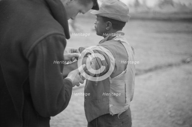 Vaccination in the camp for Negro flood refugees at Marianna, Arkansas, 1937. Creator: Walker Evans.