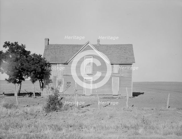 Vacant farmhouse in area of mechanization and drought near Olustee, Oklahoma, 1938. Creator: Dorothea Lange.
