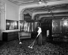 Vacuum cleaner demonstration, Frederick Gorringe's Department Store, London, 1910. Artist: Henry Bedford Lemere