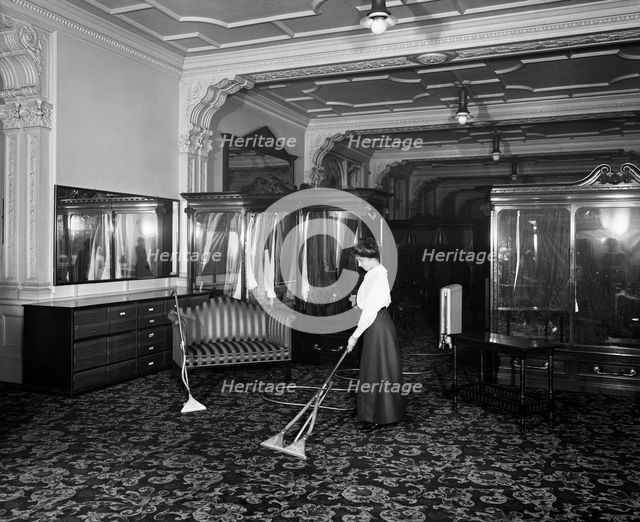 Vacuum cleaner demonstration, Frederick Gorringe's Department Store, London, 1910. Artist: Henry Bedford Lemere.