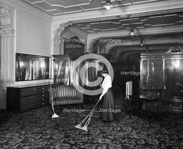 Vacuum cleaner demonstration, Frederick Gorringe's Department Store, London, 1910. Artist: Henry Bedford Lemere.