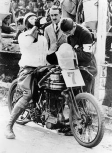 Van Horne taking a drink whilst on his Norton bike