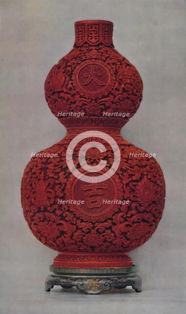 'Vase of Carved Red Lacquer on Olive Green Ground with Stand of Flat Lacquer', 1928. Artist: Unknown.