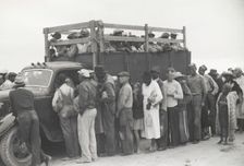 Vegetable pickers, migrants, waiting after work to be paid, near Homestead, Florida, February 1939. Creators: Farm Security Administration, Marion Post Wolcott