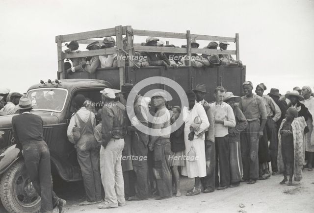 Vegetable pickers, migrants, waiting after work to be paid, near Homestead, Florida, February 1939. Creators: Farm Security Administration, Marion Post Wolcott.