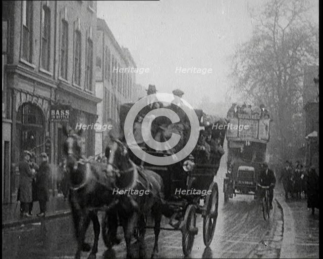 Vehicles Passing Along a Busy British Street, 1921. Creator: British Pathe Ltd.